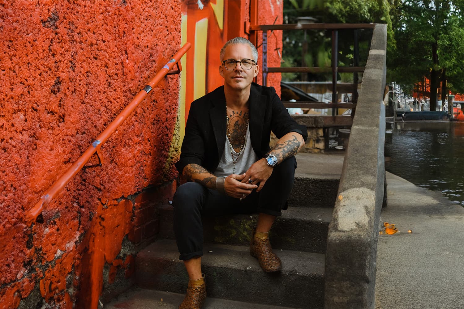Alistair Langer sitting by the water in Berlin
