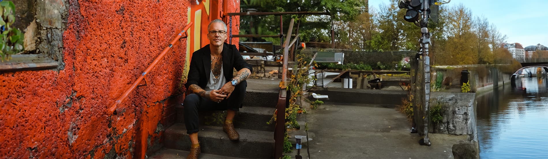 Alistair Langer sitting by the water in Berlin